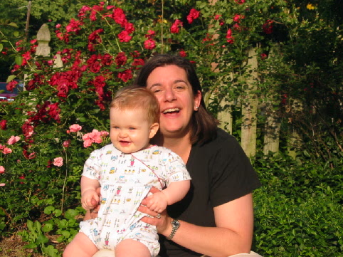 Enjoying the roses in the front yard May 27 - Bethany and Jane